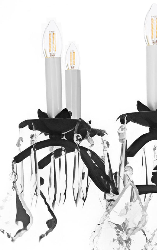 Crystal chandelier with black leaf accents on a white background