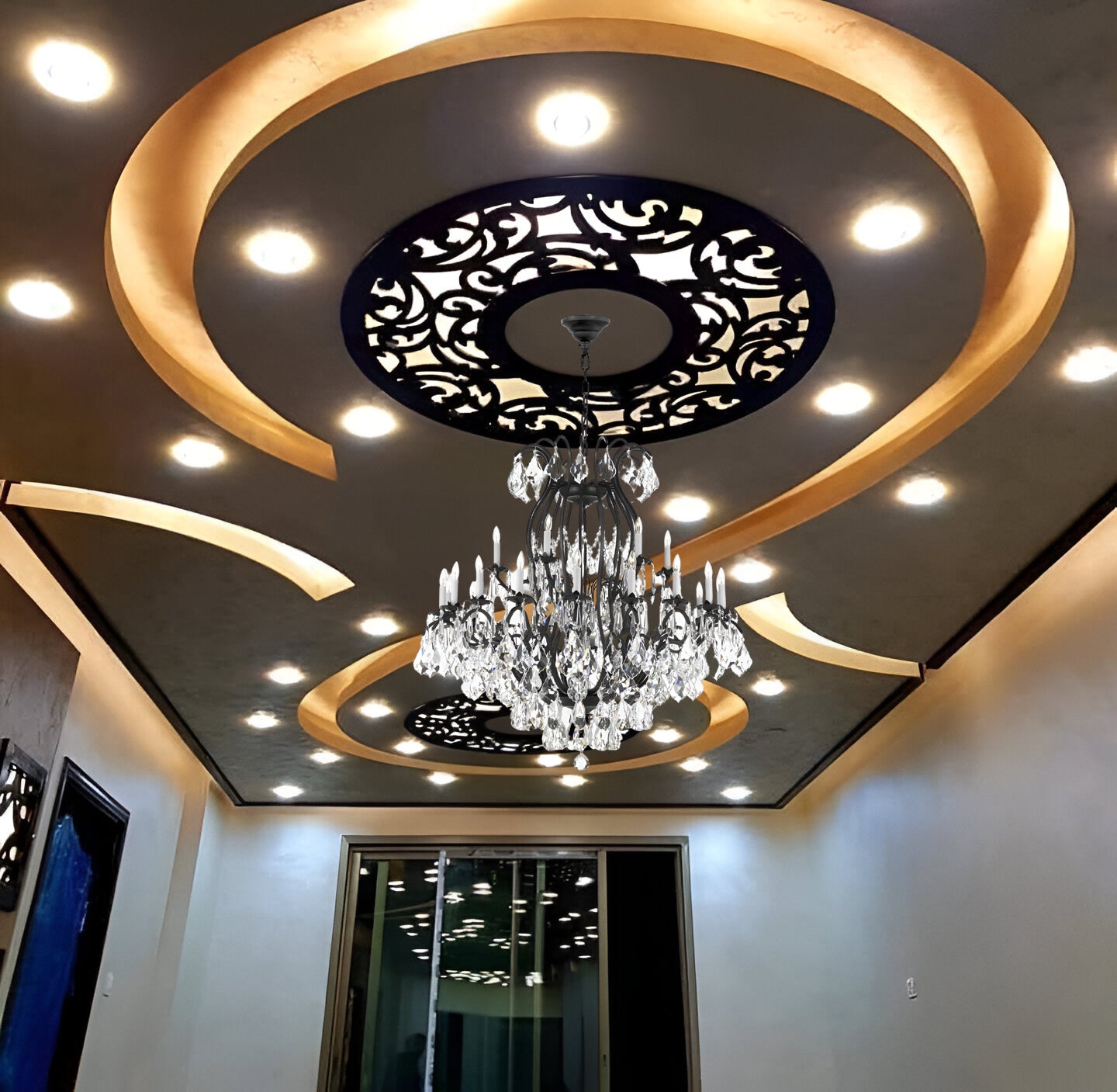 Decorative ceiling design with a chandelier and intricate patterns
